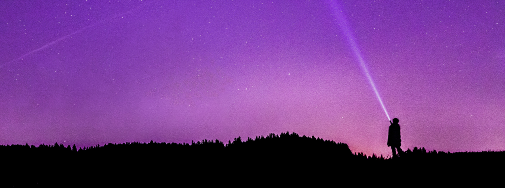 A person gazing at a starry purple sky